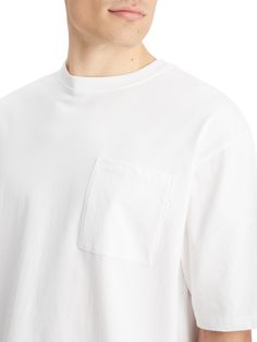 Our Loose Fit Front Pocket T-Shirt features a roomy, casual cut and a handy front pocket adorned with our signature three crosses. Perfect for those laid-back weekends or casual hangouts, this tee pairs effortlessly with jeans or shorts for a no-fuss look. Runs large; recommend sizing down 100% Cotton - Organic Wash - 30 Degrees Normal Imported White Casual T-shirt With Side Pockets, White T-shirt With Side Pockets For Everyday, White Crew Neck Top With Side Pockets, White T-shirt With Pockets For Everyday, Everyday White T-shirt With Side Pockets, White Tops With Side Pockets For Streetwear, Oversized Basic Tops With Pockets, Basic Oversized Tops With Pockets, White Cotton Tops With Side Pockets