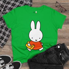 Get ready for back to school season with this adorable Miffy back to school tee! Made from soft and breathable fabric, this charming graphic tee features a cute and cheerful Miffy design that is perfect for your first day back in the classroom. Whether it's for wearing to school or just for everyday wear, this tee is sure to become a favorite in your wardrobe. Add a touch of fun and whimsy to your back to school wardrobe with this delightful Miffy tee! What's better than a soft, light cotton, quality t-shirt in your wardrobe? This comfy, contoured 100% cotton tee offers a semi-fitted silhouette and is pre-shrunk to ensure it stays a staple for longer. It features cap sleeves and a taped neck and shoulders. Miffy print on chest and back. 100% cotton  Medium fabric (5.3 oz/yd² (180 g/m Semi- Playful Funny Print T-shirt For School, Playful T-shirt For Back To School, Casual Funny Print T-shirt For Back To School, Casual Back To School T-shirt With Funny Print, Casual T-shirt With Funny Print For Back To School, Casual Back-to-school T-shirt With Funny Print, Kawaii Short Sleeve Tops For School, Casual Cotton T-shirt With Cute Design, Playful Green Tops For School