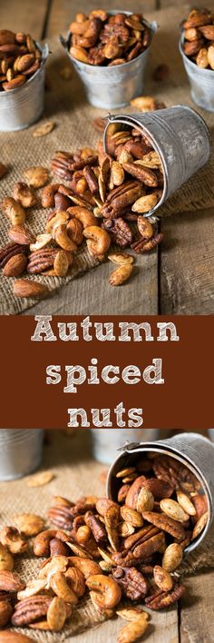 nuts in tins sitting on top of a wooden table with the words autumn spiced nuts