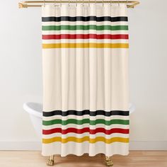 a shower curtain with multicolored stripes on the bottom and bottom, hanging in a bathroom