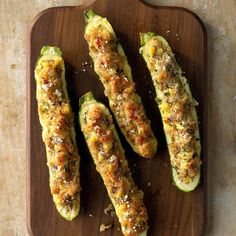 zucchini stuffed with cheese and seasoning on a cutting board