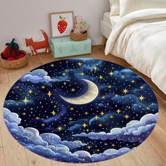 a round rug with stars and clouds in the night sky on a wooden floor next to a bed