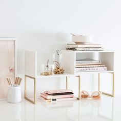 a white table topped with books and vases