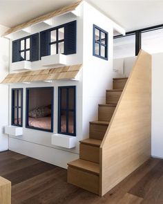 a doll house with stairs leading up to the second floor and another room on the third floor