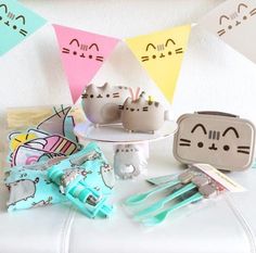 a table with toothbrushes and other items on it in front of some bunting flags