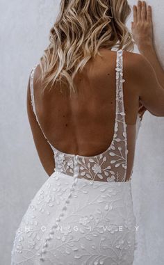 the back of a woman wearing a white wedding dress