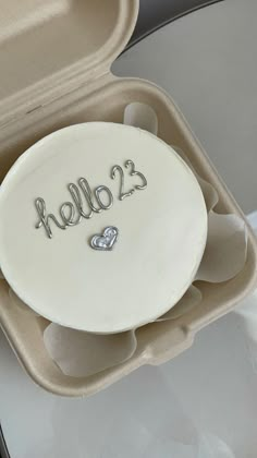 there is a cake in the shape of a heart on it's plate that says hello 23