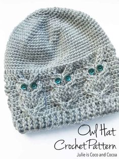 a crocheted hat with two green eyes on the front and back of it