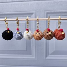 four small crocheted birds hanging from hooks