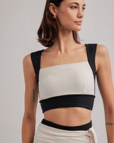 DETAILS: Color: Black & Cream Combo Square neckline bra top Nylora's signature 4-way stretch fabric Built-in bra with removable padding 77% Nylon, 23% Spandex Machine wash SIZE & FIT: Fits true to size Length: 14 3/4" Bust: 14" Bottom: 12 1/4" Model is 175cm/ 5'9" and is wearing a size Small Sporty Cream Tops, Cropped Athletic Top, Summer Cropped Black Sports Bra, Black Compressive Crop Top For Summer, Black Cropped Sports Bra For Summer, Cropped Black Sports Bra For Summer, Chic Sports Bra With Built-in Bra For Workout, Chic Workout Sports Bra With Built-in Bra, Versatile Black Crop Top With Built-in Bra