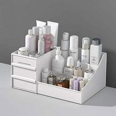 Product Description Overview: STONCEL makeup organizer is a perfect storage box for you bedroom and bathroom in hold brushes, creams, serums, tools, toners, lotions, hair spray, cotton ball and sperfume. As long as you see it, you will like it. I believe it is the cosmetic storage box you need. Advantages: Space Saver The makeup box is divided into 9 areas. Its a perfect skin care organizer for hold brushes, creams, serums, tools, toners, lotions, hair spray, cotton ball and sperfume. Also, it c Grey Makeup Organizer, Makeup Organiser Dresser, White Skincare Organizer, Bathroom Small Drawer Organization, Spinning Skincare Organizer, Ideas For Bathroom Storage, Hair Care Storage, Toner Storage, Skin Care Shelves