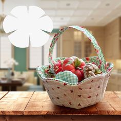 a basket filled with ornaments sitting on top of a wooden table next to a window