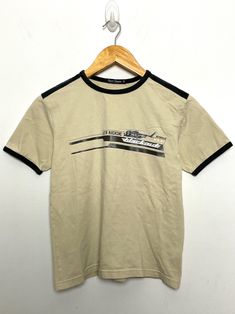 This tee shirt remains in pre owned condition. Measurements  Pit to pit: 17 inches  Top to bottom: 21 inches Brown Graphic Tee, Loungewear Women, Graphic Tee Shirts, Metropolis, Retro Outfits, Womens Clothing Tops, Tee Shirts, Graphic Tees, Lounge Wear