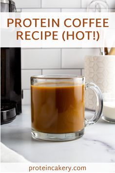 a glass mug filled with coffee sitting on top of a counter