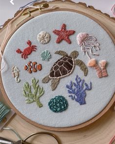 a close up of a embroidery on a piece of wood