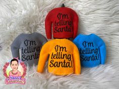 three sweaters with the words i'm telling santa written on them