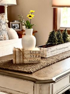 a coffee table with books and flowers on it