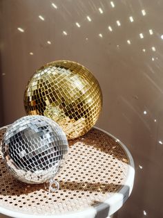 two shiny disco balls sitting on top of a table