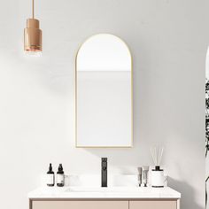 a bathroom vanity with a mirror, soap dispenser and plants