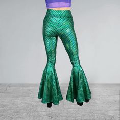 Holographic Green Mermaid Bell Bottoms High-Waisted style with 34" inseam Perfectly fitted and flattering to your body High-quality 4-way stretch holo spandex Handmade in the USA Made of stretchy metallic mermaid scale print in green - these high-waisted mermaid bell bottoms will fit you perfectly. They hug your hips and flare out at the feet. This color is stunning! The inseam is 34" and can be customized by specifying in the personalization box. *Our model typically wears a size 4, has a 27" waist, 37.5" hips and is 5'5" tall. She is wearing our size small with the standard 34" inseam and 3" heels. Party Fitted Green Pants, Green Fitted Pants For Party, Fitted Full Length Green Bottoms, Fitted Full-length Green Bottoms, Green Fitted High Waist Bottoms, Fitted High Waist Green Bottoms, Fitted High Waist Green Leggings, Green High Waist Fitted Bottoms, High Waist Fitted Green Bottoms