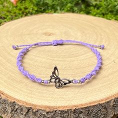 Stylish handmade bracelet, braided in spiral design from waxed cord in purple colour, decorated in the middle with metal butterfly charm and small silver coloured metal beads. The bracelet's thickness is about 5mm and it fastens with a sliding knot, so you can adjust the size to fit perfectly. Minimum diameter of the bracelet when it's closed is 15-16cm. and the fastening threads allows it to be opened to around 28-30cm. The charms size is 19x13mm. If you need specific size please let us know, c Braided Nylon Cord Bracelets For Gift, Lavender Casual Jewelry For Gifts, Braided Nylon Cord Bracelets As Gift, Purple Adjustable Bracelets As Gift, Casual Purple Jewelry For Festival, Nylon Cord Braided Bracelet As Gift, Casual Handmade Lavender Jewelry, Adjustable Purple Friendship Bracelets For Beach, Purple Adjustable Friendship Bracelets As Gift