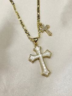 Add a touch of elegance and faith to your jewelry collection with this stunning 14k gold filled double cross necklace. The standout piece features a large cross pendant adorned with shimmering opal shell detailing, complemented by a delicate cubic zirconia cross charm. Perfect for adding a glamorous touch to any outfit, this necklace is sure to make you shine bright wherever you go. Ideal for those who want to showcase their faith with style and sophistication. 17.5 inch length with optional 2 inch extender chain Double Cross Necklace, Shell Cross, Future Board, Cross Pendent, Streetwear Jewelry, Pink Cross, Catholic Jewelry, Jewelry Accessories Ideas