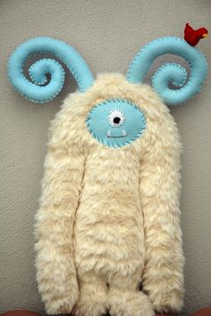 a stuffed animal with blue eyes and ears