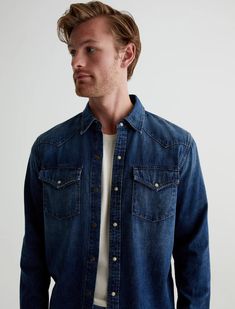 Experience modern Americana style with the AG Men's Aiden Western Shirt - Exhibition. Made from 100% cotton in a faded indigo wash, this classic denim shirt features angled shoulder panels, flap pockets, and snap buttons. Crafted from 7 Oz. Heritage 2X1 Denim, this shirt offers comfort and durability. Unstructured Washed Shirt In Medium Wash, Classic Washed Shirt With Relaxed Fit, Classic Relaxed Fit Pre-washed Shirt, Classic Fitted Washed Shirt, Modern Americana, Americana Style, Americana Fashion, Vintage Americana, Ag Jeans