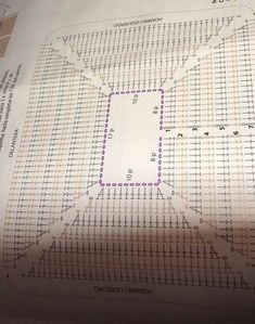 a piece of paper that is laying on top of a sheet of paper with a drawing of a square in the middle