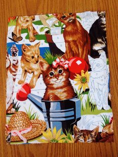 there are many cats and kittens on this square piece of fabric that is sitting on the table