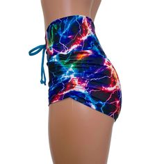 High-waisted booty shorts made in sparkle cosmic thunder UV Glow print stretchy performance spandex with ruching on the sides and lace-up detail in front. Made to flatter your figure and move with you. These booty shorts shine in different colors in the light - for a true holographic effect. The standard inseam is 2.5" - but can be customized. Sporty Fitted Shorts With Tie-side Bottom, Fitted Rave Bottoms With Built-in Shorts, Stretch Sports Shorts With Tie-side Bottom, Sports Stretch Shorts With Tie-side, Stretch Sports Shorts With Tie-side, Fitted Tie-side Workout Bottoms, Sporty Fitted Tie-side Bottoms, Fitted Sports Shorts With Drawstring, Fitted Rave Shorts