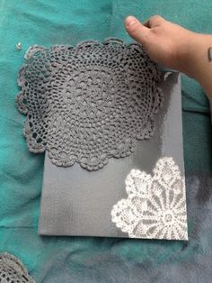 someone is holding onto some doily to make something look like it has been made