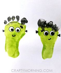 two handprints made to look like green monster hands with googly eyes and black hair