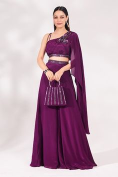 Plum padded top embellished with cutdana, sequins and beads embroidery. Paired with waistband embroidered palazzo and matching bag. - Aza Fashions Bollywood Style Palazzo Set With Unstitched Blouse For Evening, Evening Choli With Cutdana For Eid, Evening Palazzo Saree Set With Sequins, Sequin Palazzo Saree Set For Evening, Embellished Palazzo Set For Evening Party Wear, Cutdana Choli For Evening And Eid, Embellished Palazzo Set For Evening, Embellished Dupatta For Evening Navratri, Cutdana Sets For Evening Navratri Festival