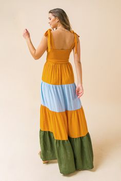 A maxi dress featuring a smocked bodice, tie straps, and a color block tiered skirt Details Self: 80% Rayon, 20% Nylon Contrast: 80% Rayon, 20% Nylon Lining: 100% Polyester Size & Fit - Model is 5`8" And Wearing Size Small - Measurements Taken From Size Small - Approx. Length: 50" Fitted Maxi Dress With Tie Back For Casual Wear, Fitted Maxi Dress With Tie Back For Casual Occasions, Chic Maxi Dress With Tie Back, Chic Tiered Skirt Dress With Tie Back, Sundress With Tiered Skirt And Tie Back, Fitted Tiered Skirt Sundress, Tie Back Tiered Skirt Sundress, Sundress With Tie Back And Tiered Skirt, Casual Long Dress With Tie Back