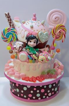 a cake decorated with candy, candies and lollipops