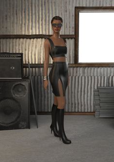 a woman in a leather outfit standing next to a speaker and amp with an empty screen behind her