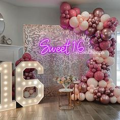 a room decorated with balloons and lights for sweet 16