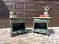 two green nightstands sitting next to each other on top of a rug in front of a garage door