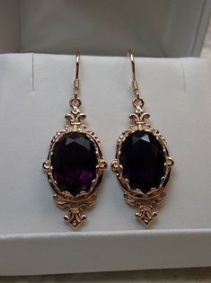 "Simulated Purple Amethyst Earrings Pin Design#E18 Custom Made These are Victorian reproduction estate earrings in rose gold plated sterling silver with flawless simulated purple amethyst gemstones. Each stunning 6ct gem is 14mm long (9/16th\") and 10mm in width (3/8th\"). The earrings are 1 3/4th inches long. Notice the beautiful fleur de lis on the bottom and top of the setting. These lovely earrings were fashioned from an antique Victorian floral brooch. A gift box is included and all items a Purple Amethyst Earrings, Goth Outfit, Prom 2023, Jewellery Design Sketches, Pin Design, Purple Jewelry, Floral Brooch, Classic Earrings, Jewelry Lookbook