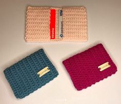 three crocheted wallets sitting next to each other