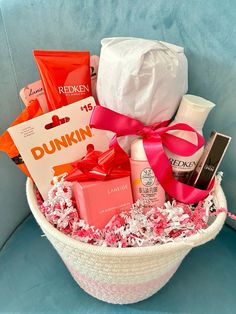 a white basket filled with lots of different types of items on top of a blue chair