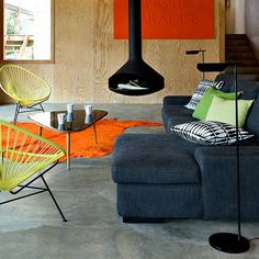 a living room filled with furniture next to a fire place