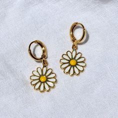 These earrings feature 24k gold plated 14x17mm daisy charms attached to 12mm hoops. Tarnish resistant, lead and nickel free. Matching necklace here. Full necklace and earrings set available here. Cute Gold Jewelry With Flower Charm, Small Hoop Jewelry With Flower Charm For Everyday, Everyday Small Hoop Jewelry With Flower Charm, Gold Daisy Earrings With Flower Charm, Adjustable Yellow Daisy Jewelry, Handmade Daisy-shaped Jewelry For Everyday, Handmade Daisy-shaped Everyday Jewelry, Yellow Daisy Shaped Jewelry Gift, Everyday Handmade Daisy-shaped Jewelry