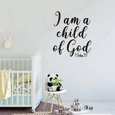 a baby's room with a crib and wall decal that says i am a child of god