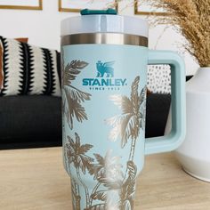 a travel mug sitting on top of a wooden table