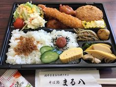 a bento box filled with rice, meat and veggies