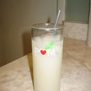 a glass filled with milk sitting on top of a counter