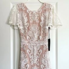 Nwt For Love & Lemons San Marcos Ivory Floral Lace Open Back Mini Dress! Description: Stunning Mini Dress!!! Perfect For A Summer Concert, Date Night Or Any Special Occasion:) Size: S Color: Ivory Fabric: Self: 40% Polyamide, 40% Cotton, 20% Polyester Lining: 87% Polyester, 13% Spandex Details: Floral Ivory Lace, Short Flutter Sleeves, Curving Hugging, Wispy Hem, Gorgeous Open Back, Hidden Side Zip, Fully Lined In Contrasting Nude. Measurements: Taken Flat Shoulders: Approx. 15" (Seam To Seam) C Feminine Cream Dress With Scalloped Lace, Feminine Wedding Maxi Dress With Lace Sleeves, White Lace Trim Dress For Wedding Night, White Bridesmaid Dresses With Lace Trim, White Lace Dress With Lace Sleeves For Bridesmaid, White Lace Dress For Bridal Shower, Fitted White Maxi Dress With Lace Sleeves, White Fitted Maxi Dress With Lace Sleeves, White Short Sleeve Dress With Lace Bodice