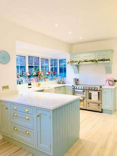 a kitchen with blue cabinets and white counter tops